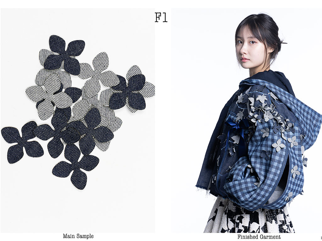 Woman stands on right modelling material with piece of material on show on left.