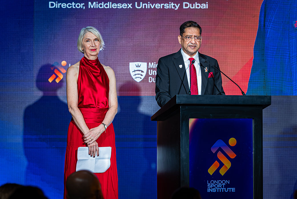 Two people on a podium at an event