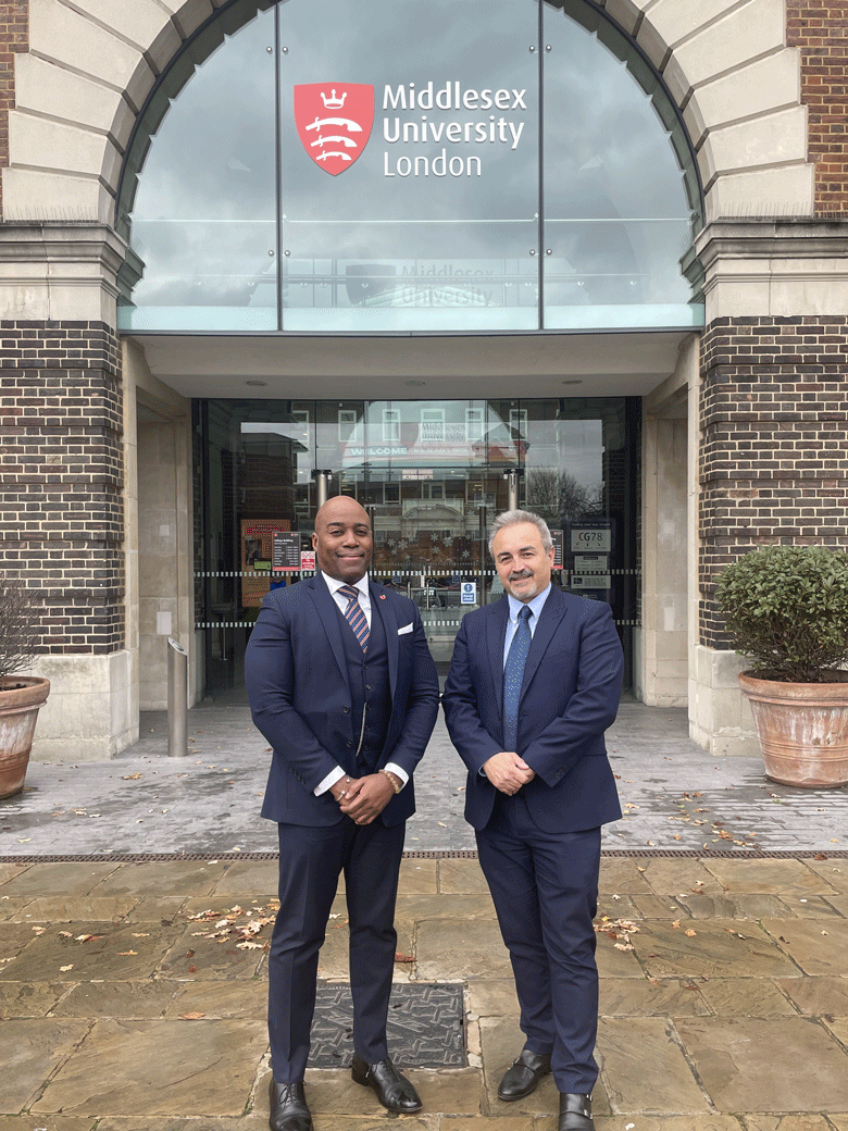 Two men in dark suits - Prince Kamari, economic adviser to a Nigerian ruler, and Middlesex academic Prof George Dafoulas - stand outside Middlesex University College Building