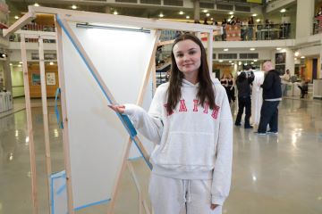 A student tests a stage prop she has designed.