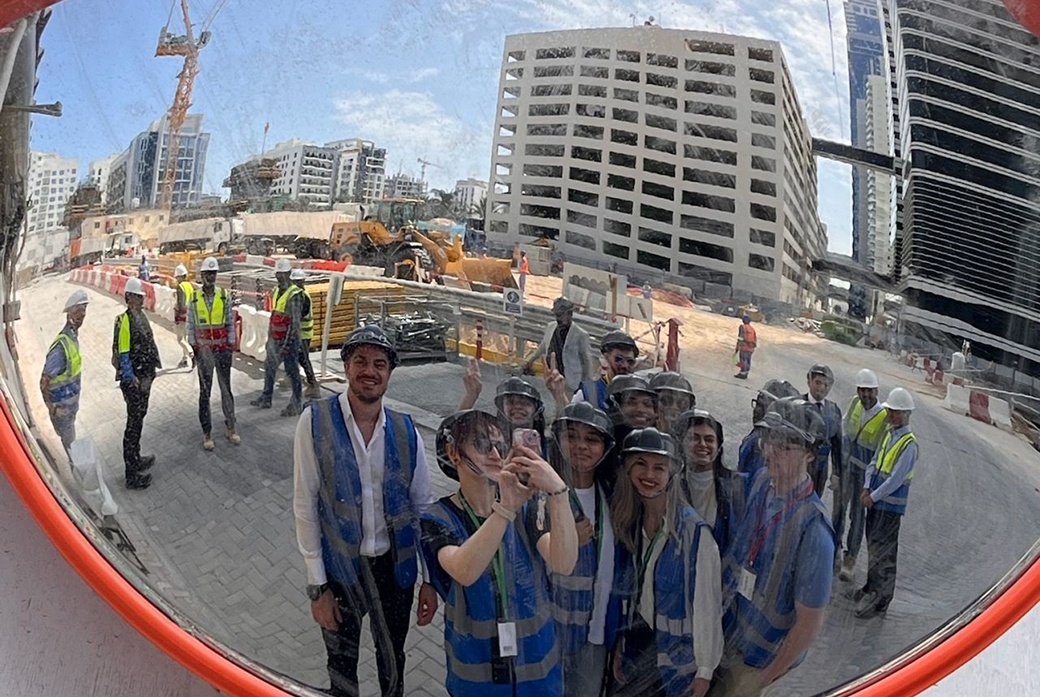Students take selfie in mirror on construction site
