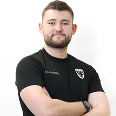 A sports student looks at the camera
