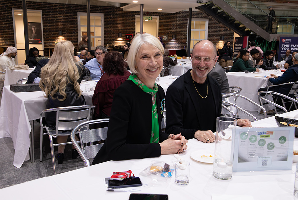 Two people sat at table during iftar celebration at a university