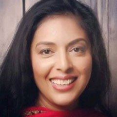 A woman looks at the camera