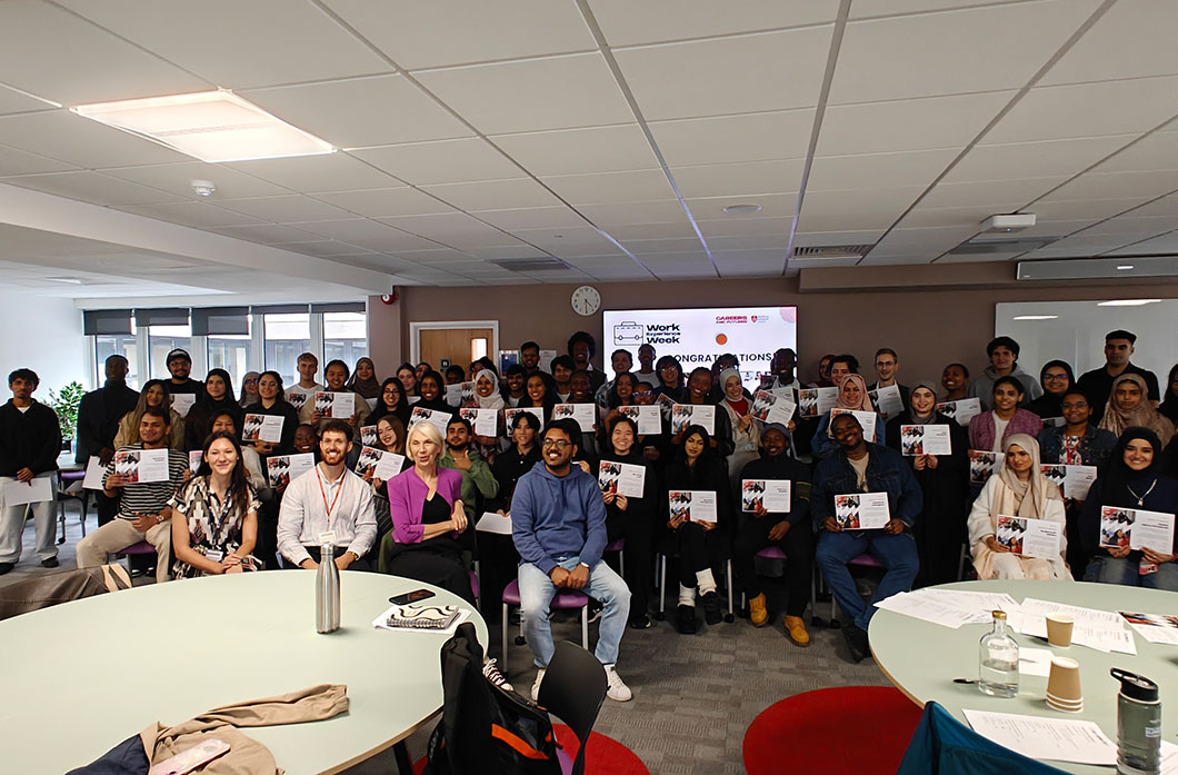 People in a classroom hold certificates
