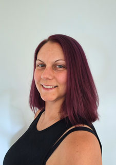 Mdx alumni Nicola Coleman with dark brown hair and black top.