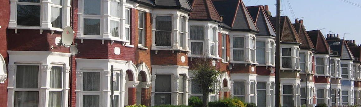A picturesque street with a row of charming houses, creating a harmonious and inviting neighborhood ambiance.
