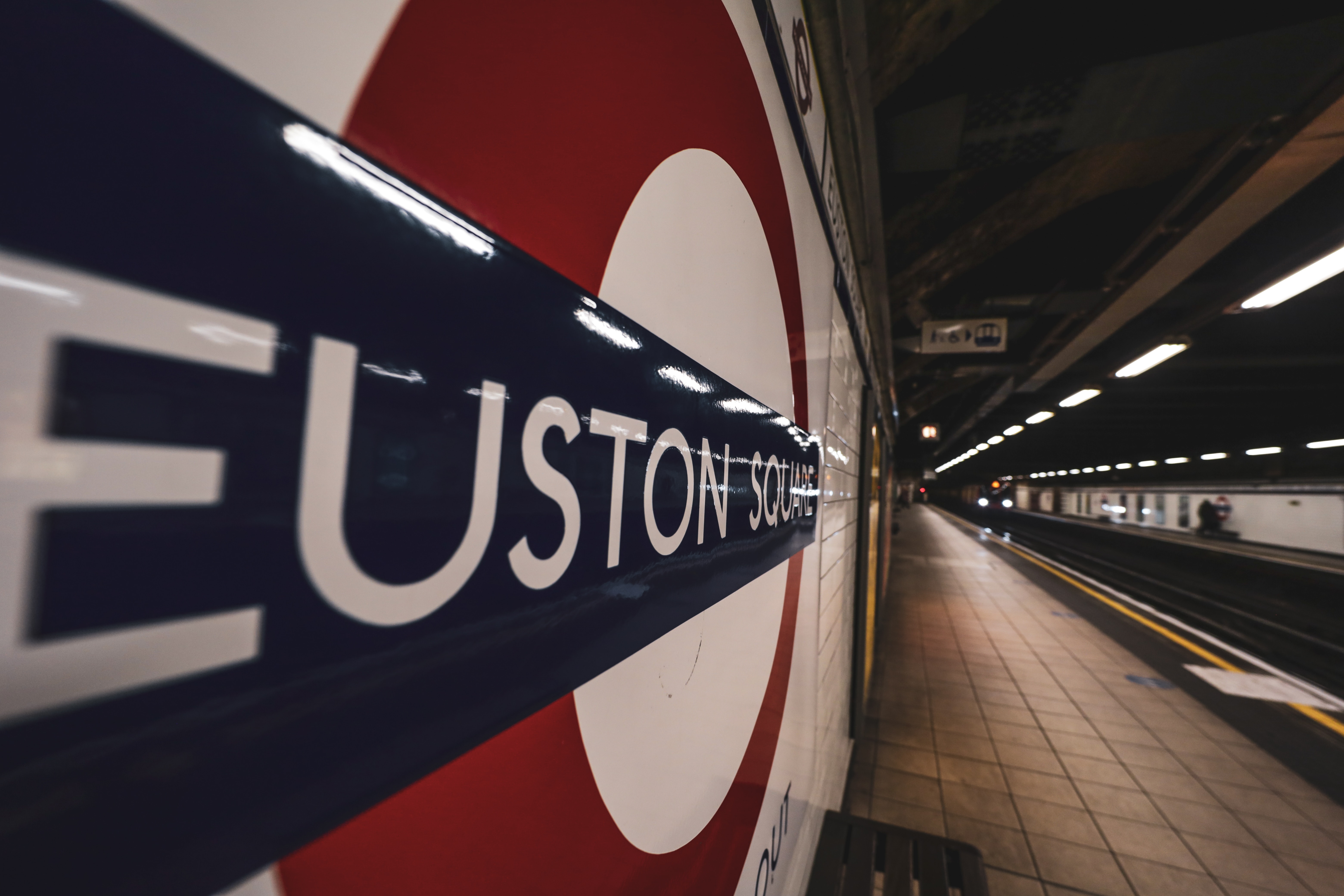 euston square underground sign on empty tube platform