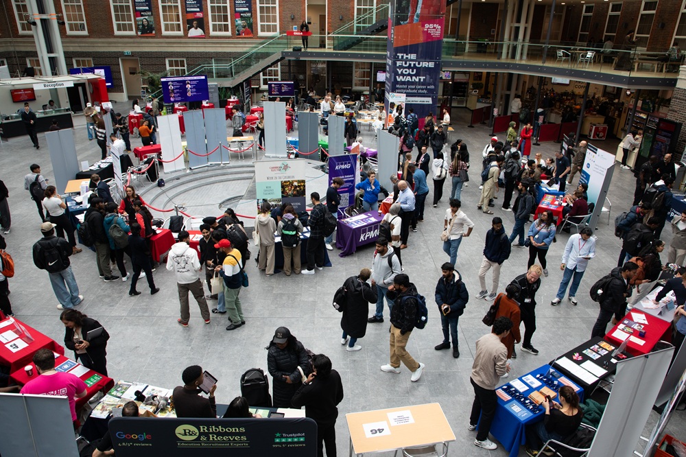 An elevated shot of lots of students attending stalls for Gradstock 2025 in Middlesex University London's College Building