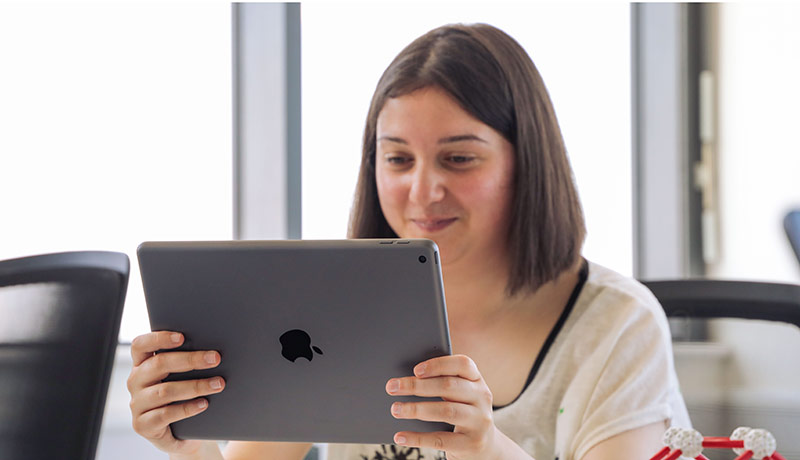 Female student looking at an iPad.