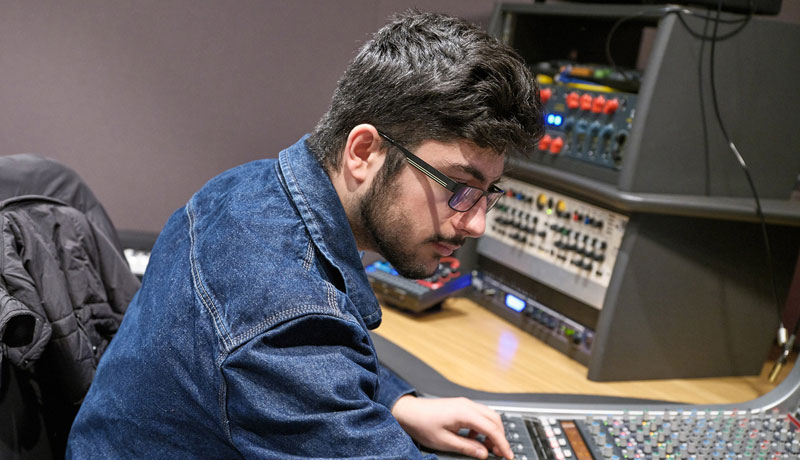 Student at audio mixing desk