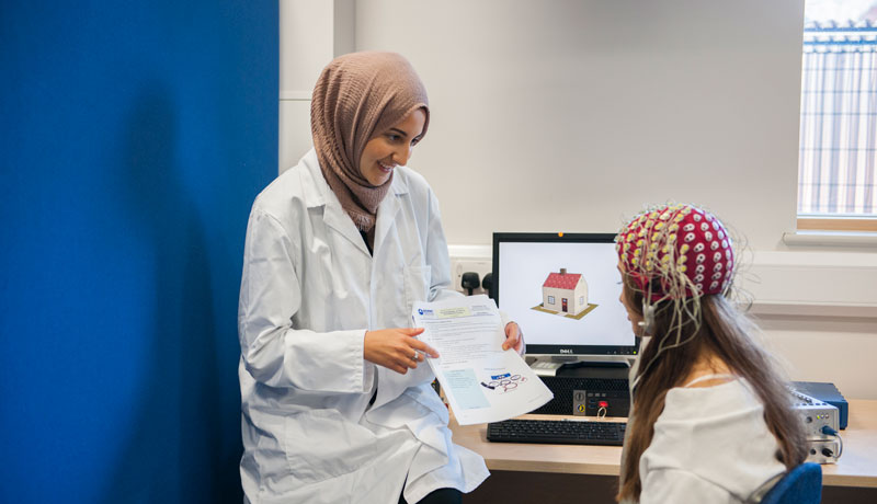 Psychology student examines a patient.