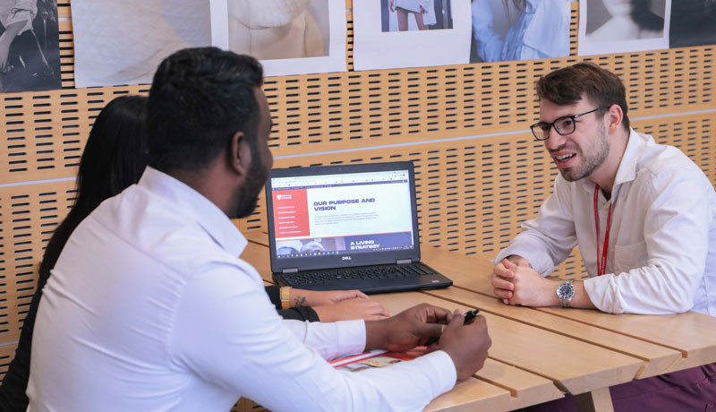 Students talking to staff member