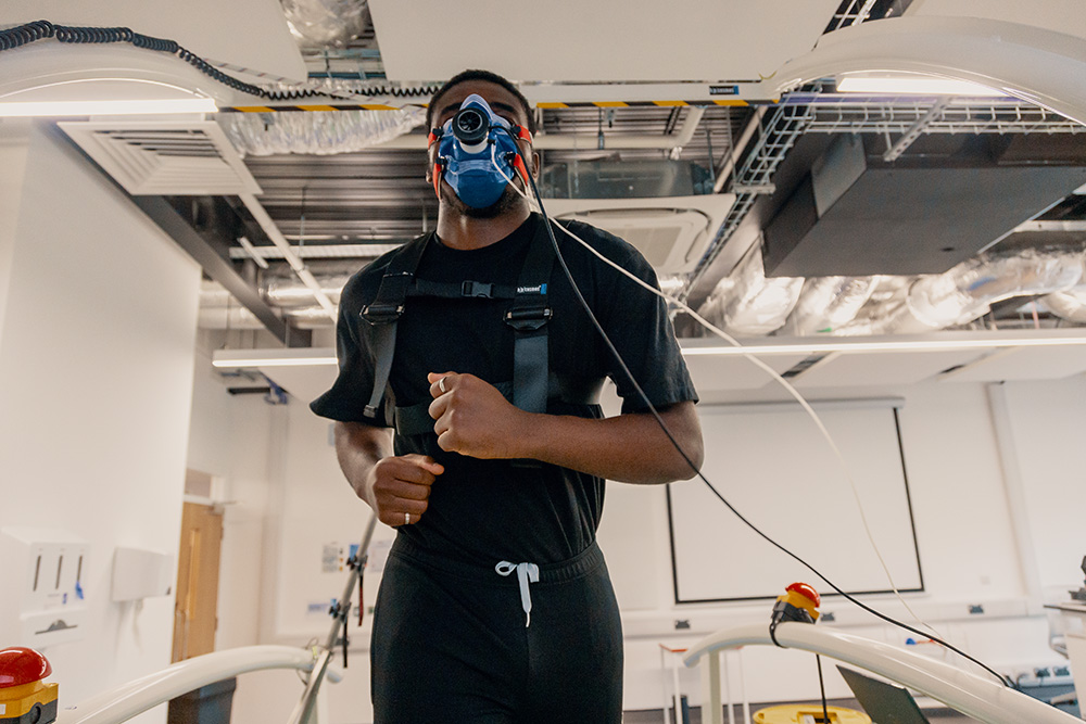 A student running with a mask on their face